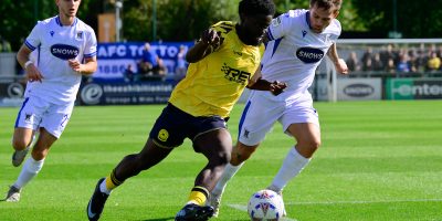 Denzel Akyeampong of Torquay United and Craig Tanner of AFC Totton challenge for the ball during the Emirates FA Cup Second Qualifying Round match between AFC Totton and Torquay United at The Snows Stadium, Southampton on 13 September 2025 (Photo: Alan Stanford/PPAUK)