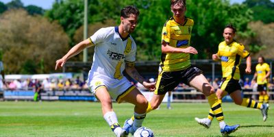 Jordan Young of Torquay United challenges for the ball with Will Hall of Buckland Athletic during the Pre Season Friendly match between Buckland Athletic and Torquay United at The VX3 Stadium, Homers Heath, Newton Abbot, Devon on Saturday 12 July 2025. Photo: Frankie OKeeffe/PPAUK
