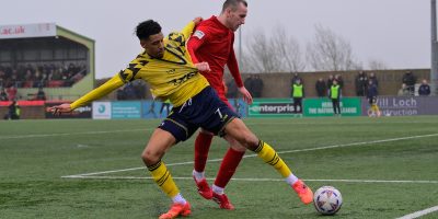 Louis Dennis of Torquay United and Adam May of Eastbourne Borough during the National League South match between Eastbourne Borough and Torquay United at Priory Lane, Eastbourne on 21 February 2026. Photo: Alan Stanford/PPAUK